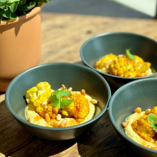 Roasted cauliflower with spices, Gochujang honey, hummus and roasted pine nuts |