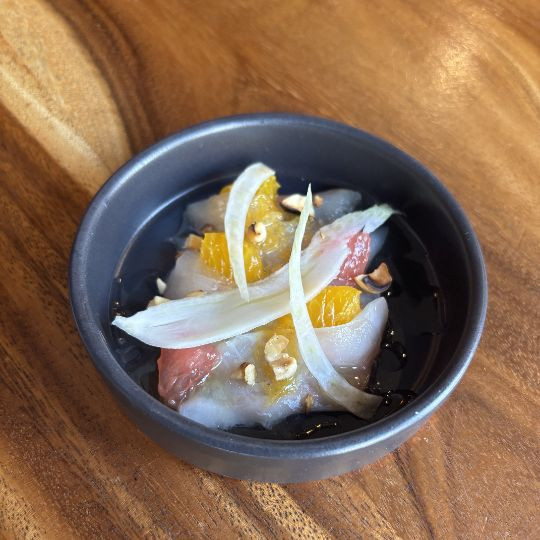 Crudo de dorade à la clémentine, fenouil croquant, noisettes torréfiées et huile aux herbes du maquis